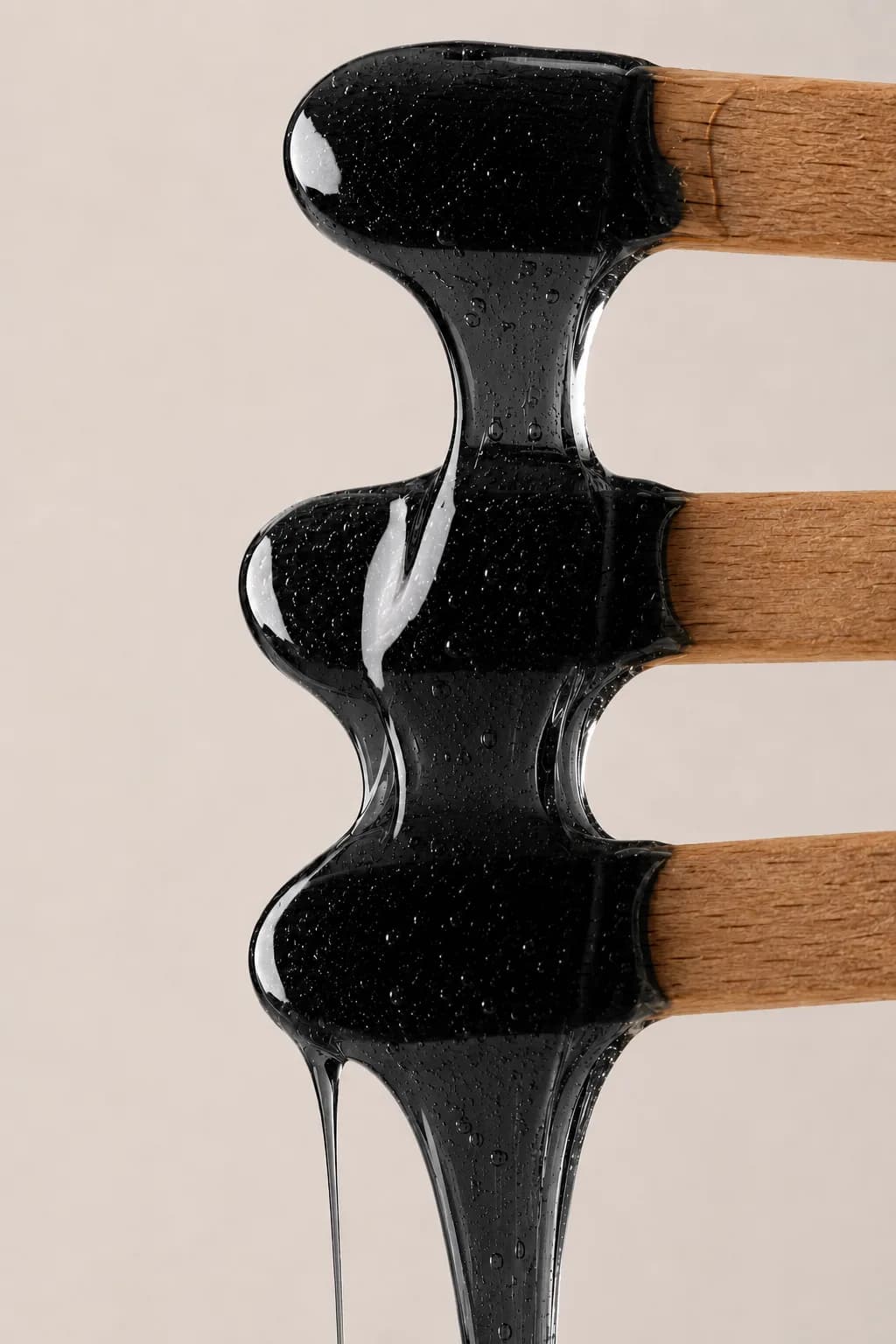 Warm sugar wax drawn between spatulas